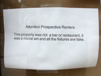 Sign: 'This property was not a bar or restaurant, it was a movie set and all the fixtures are fake.'